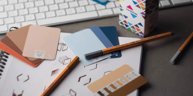 Graphic design workspace with colour palettes and sketches.